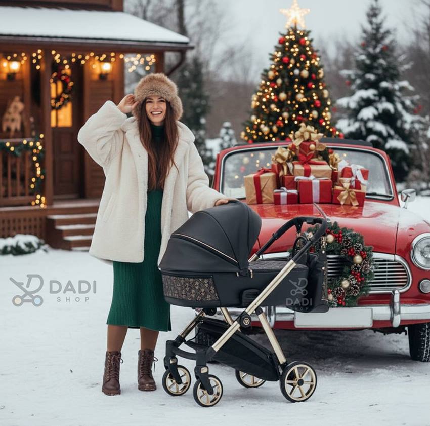 Kobieta w puchowej czapce pozuje z wózkiem Junama Ellente Art Deco w zimowej, świątecznej scenerii, w tle czerwone retro auto,